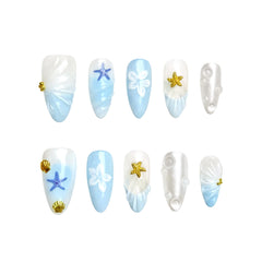 Blue almond press-on nails with shell and starfish accents, handmade in a coastal summer design.