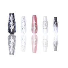 Black and pink press on nails in coffin shape with ombre gradient, pearl accents, silver lines, and skeleton motif.