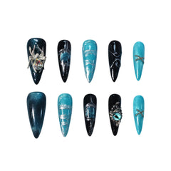 Black and silver stiletto press on nails with icy turquoise tones, 3D spider and snake charms, and marbled metallic accents.