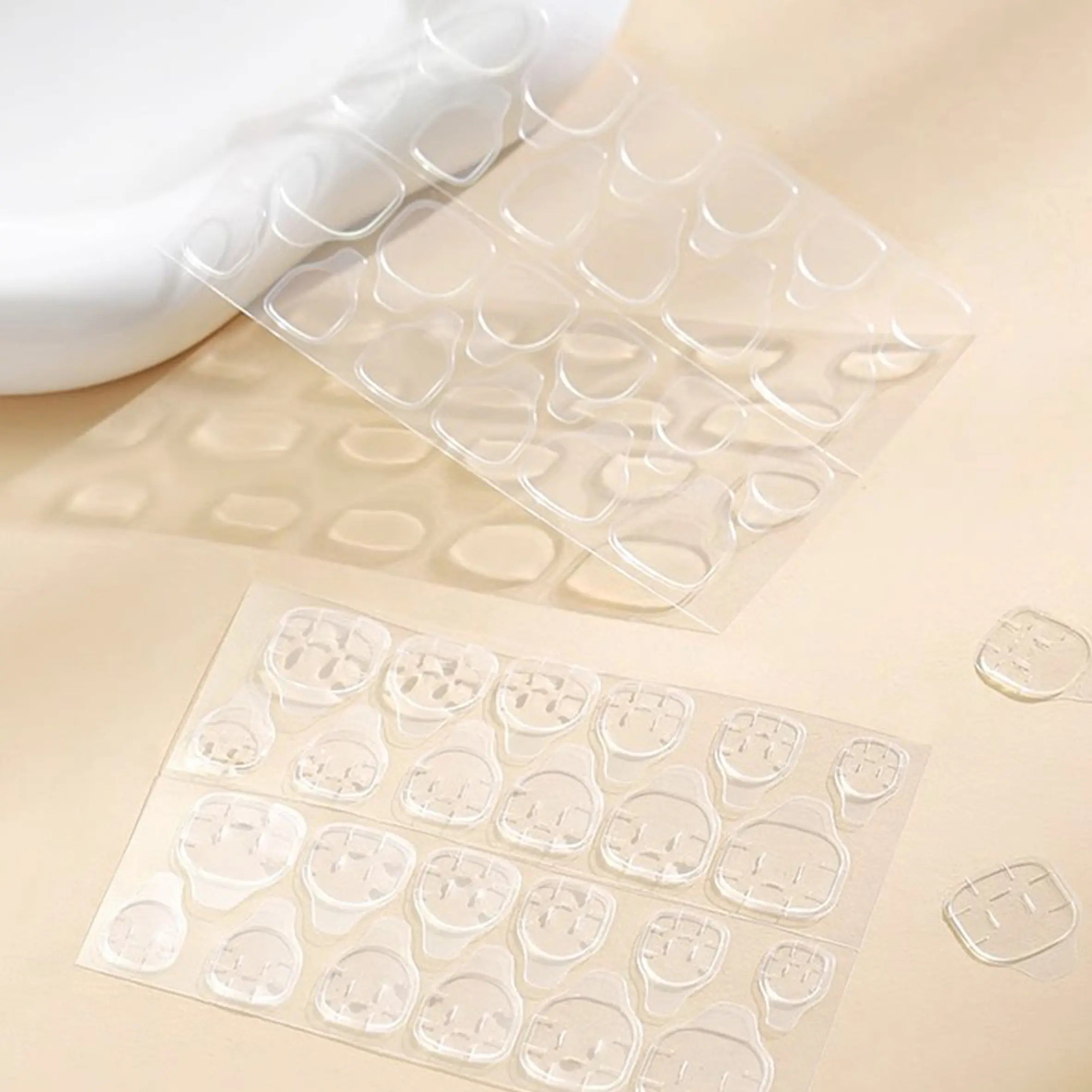 Polippie solid glue tabs for press-on nails, 2 sheets of 24 clear adhesive stickers.