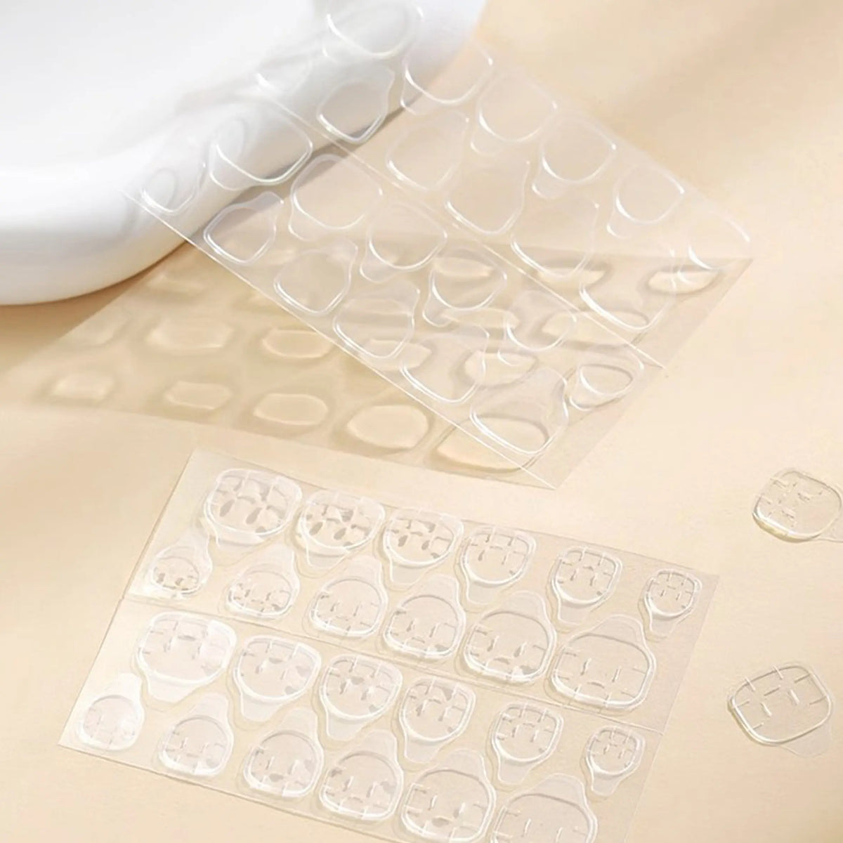 Polippie solid glue tabs for press-on nails, 2 sheets of 24 clear adhesive stickers.