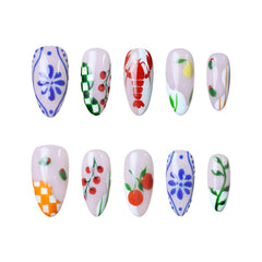 Short almond press on nails with cherry, daisy, vine, and pastel checkered patterns.