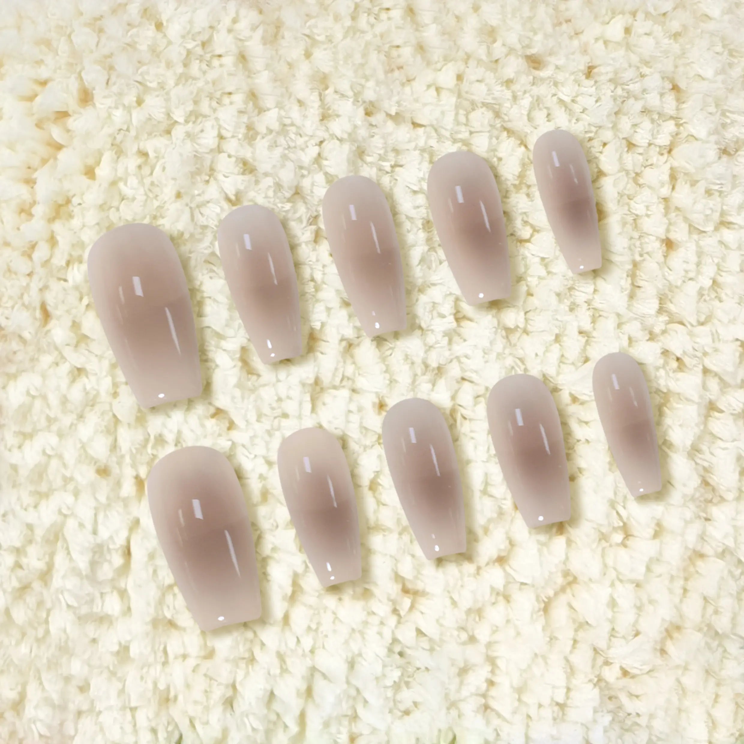 Glossy nude amber medium coffin press-on nails with gradient finish for a minimalist, elegant look.