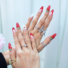 Romantic summer nails in almond shape featuring red-white fade and dimensional fruit and pearl accents