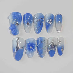 Medium blue almond press on nails with icy silver lines and embedded floral details.