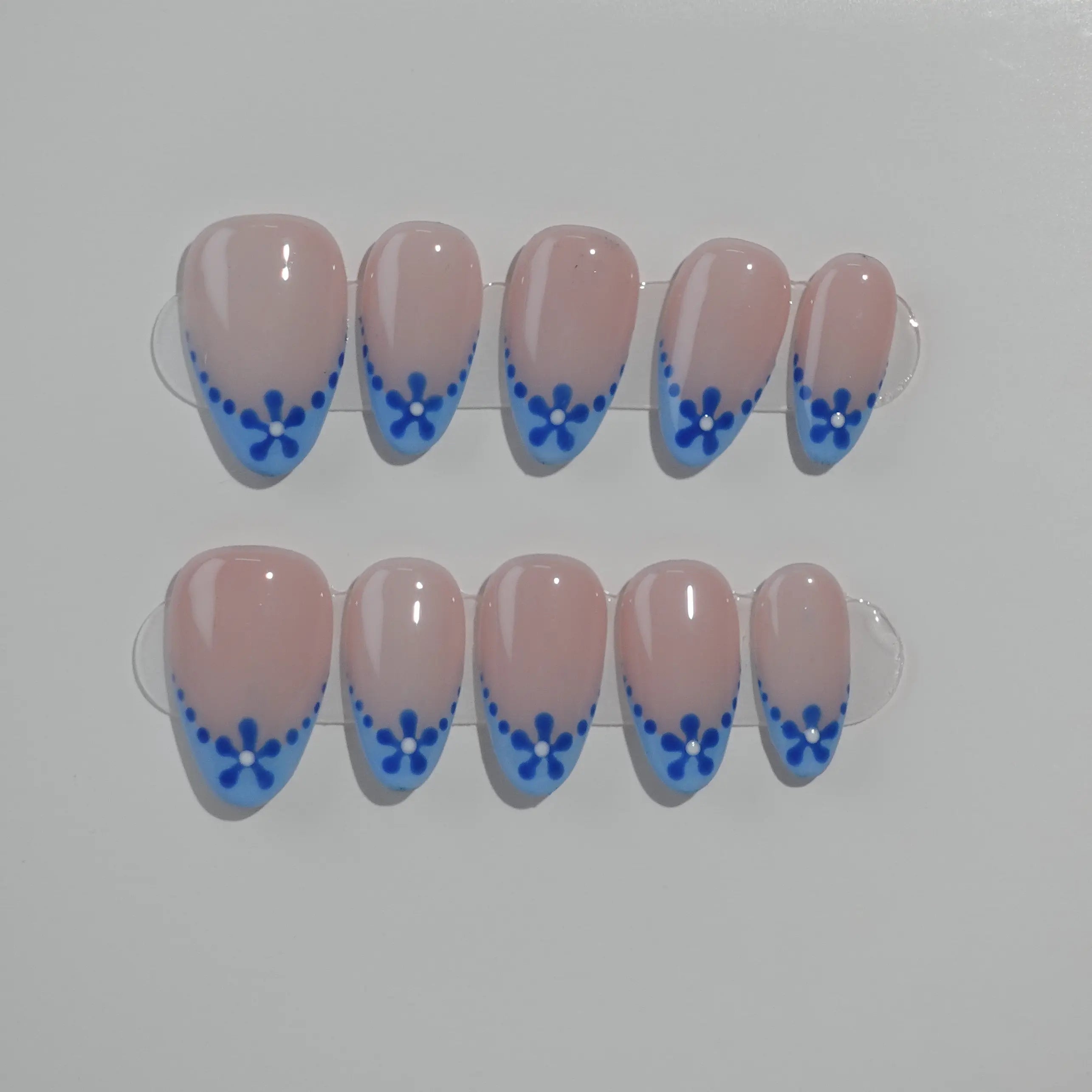 Elegant blue almond press on french nails with pink base and floral tips.