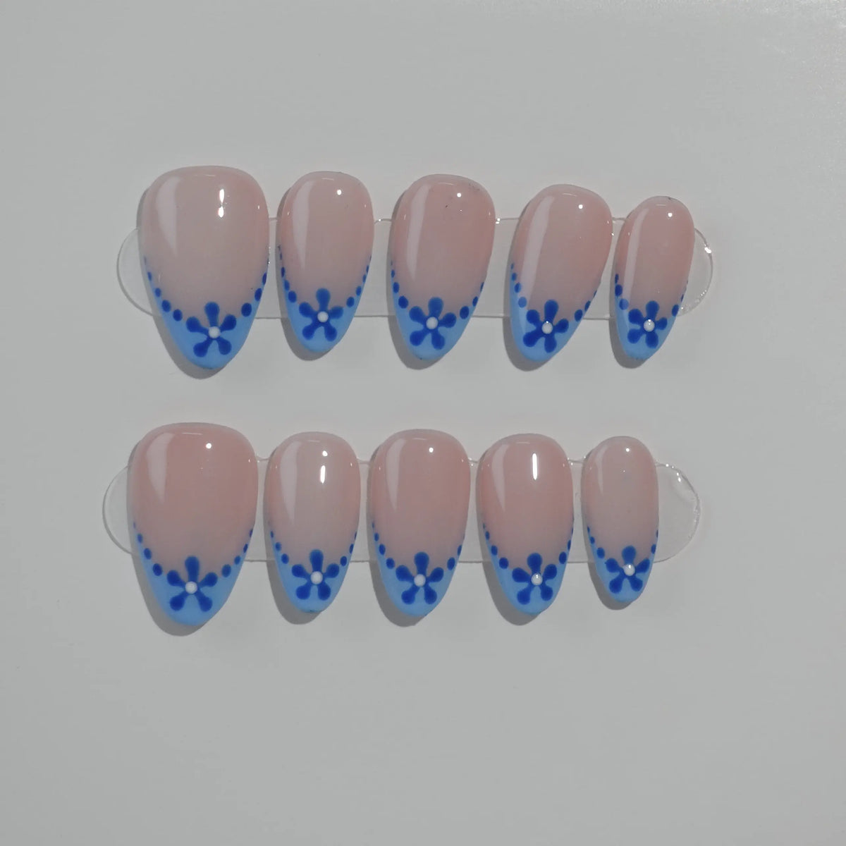Elegant blue almond press on french nails with pink base and floral tips.