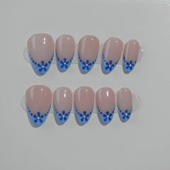Elegant blue almond press on french nails with pink base and floral tips.