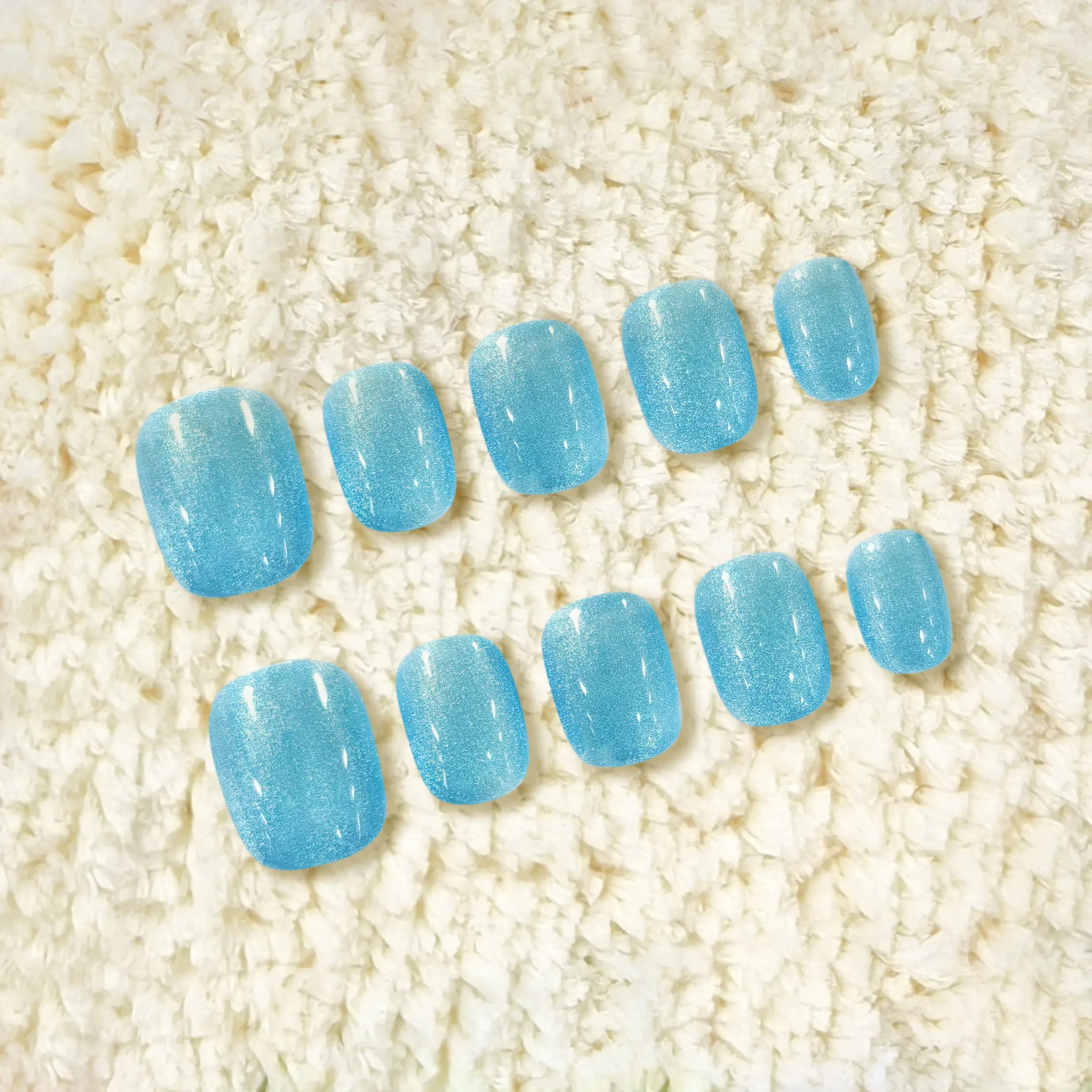 Display of short glacier-blue nails for product details