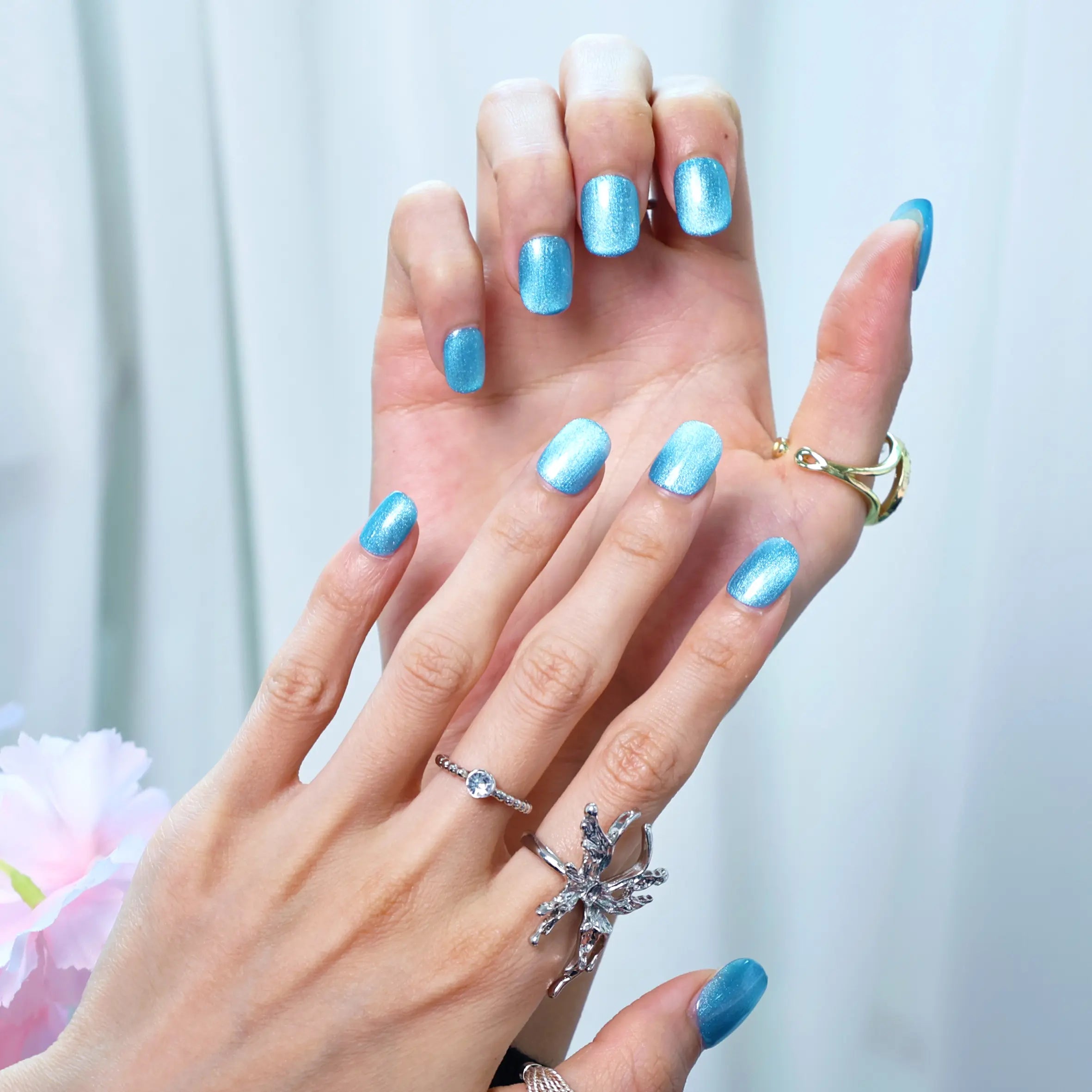 Flat lay of press-on nails in frosty sky blue sparkle