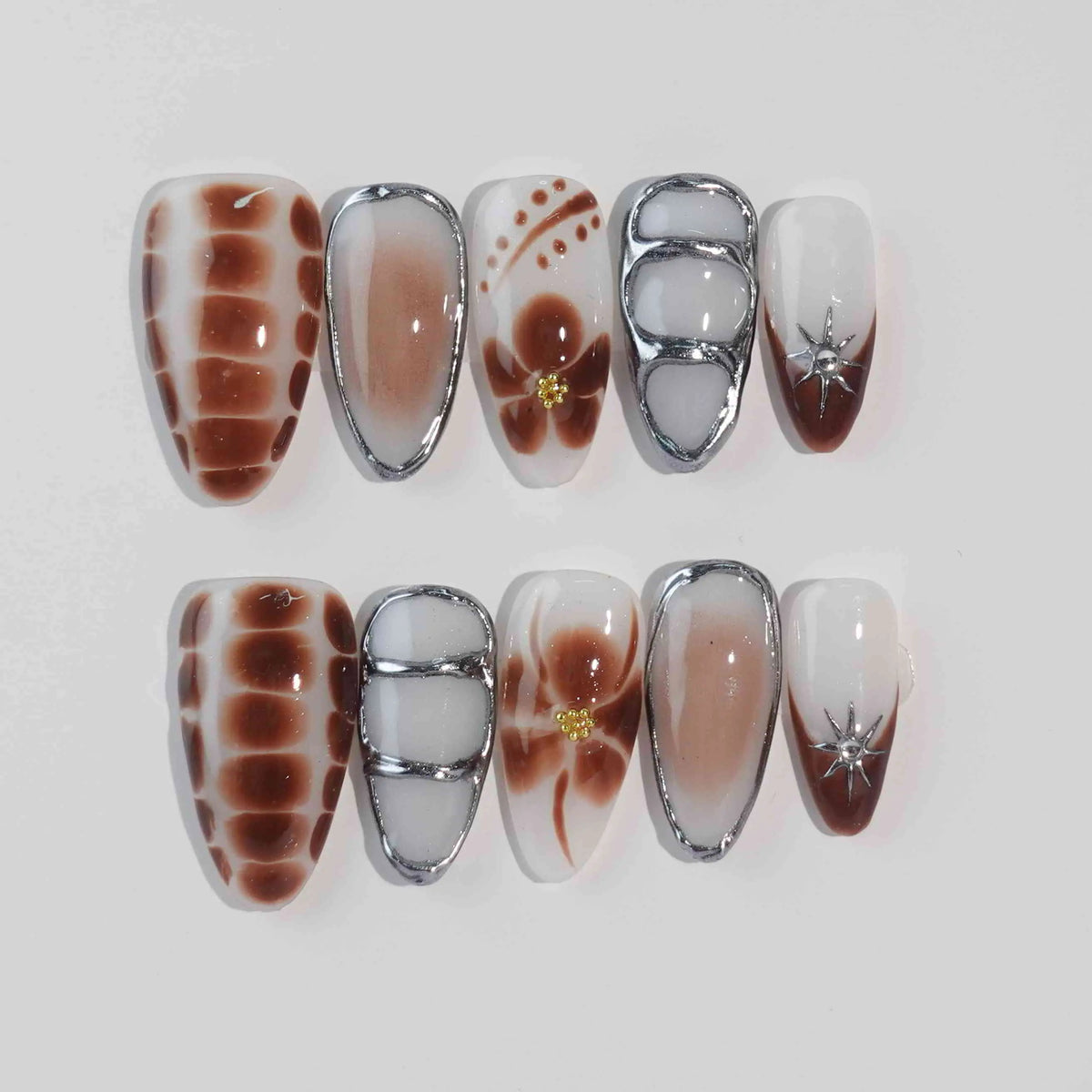 Almond-shaped brown press on nails with marble design, ideal for fall or coffee-inspired looks.