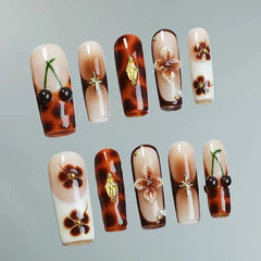 Long Coffin press on nails with tortoiseshell patterns and raised daisy flowers.