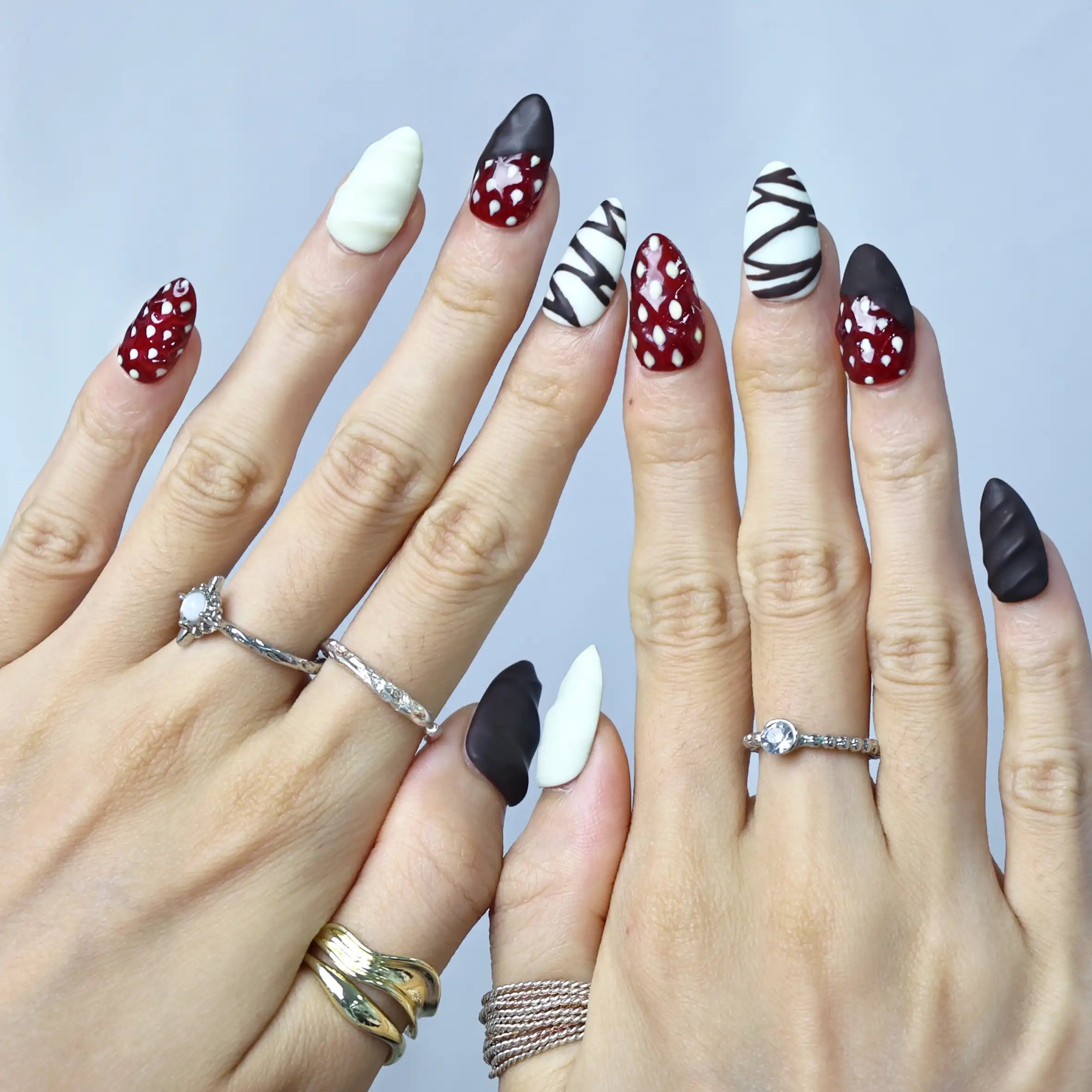 Sweet and stylish nails in brown, white, and pink with a matte texture and candy-like details
