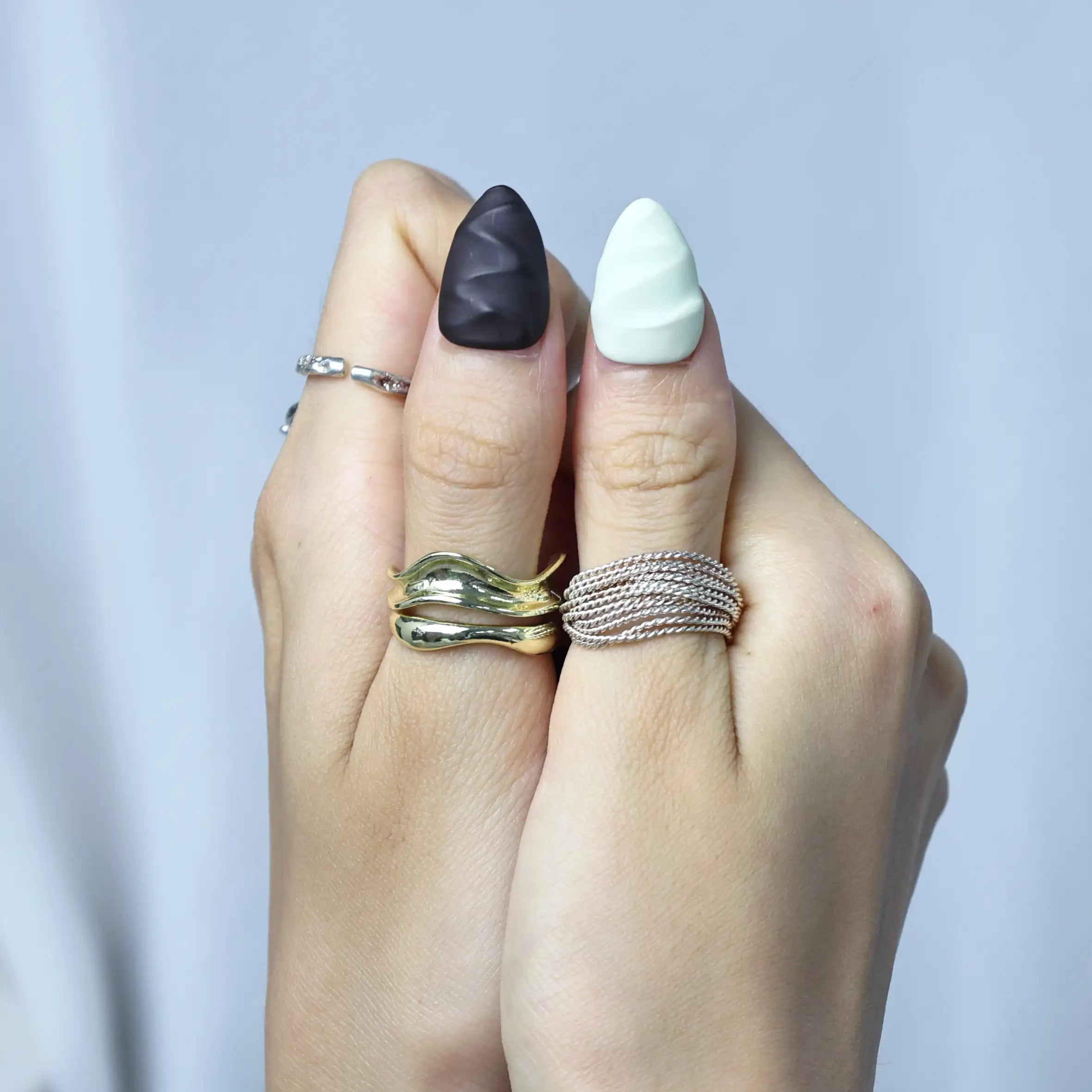 Fun and elegant nails in almond shape with matte cocoa tones, white swirls, and fruity accents