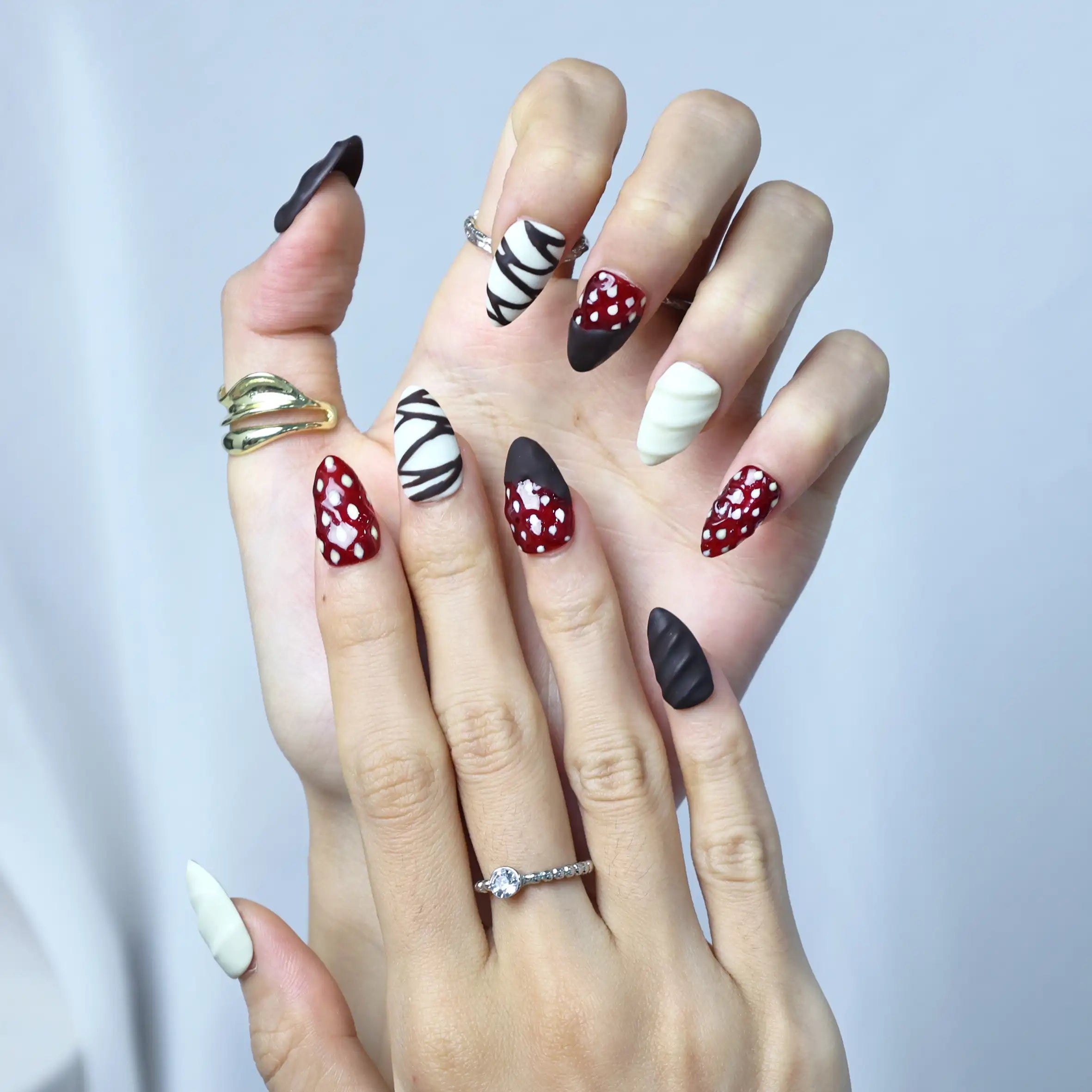 Nail set styled for chocolate and strawberry lovers with artistic swirls and 3D fruit designs in soft tones