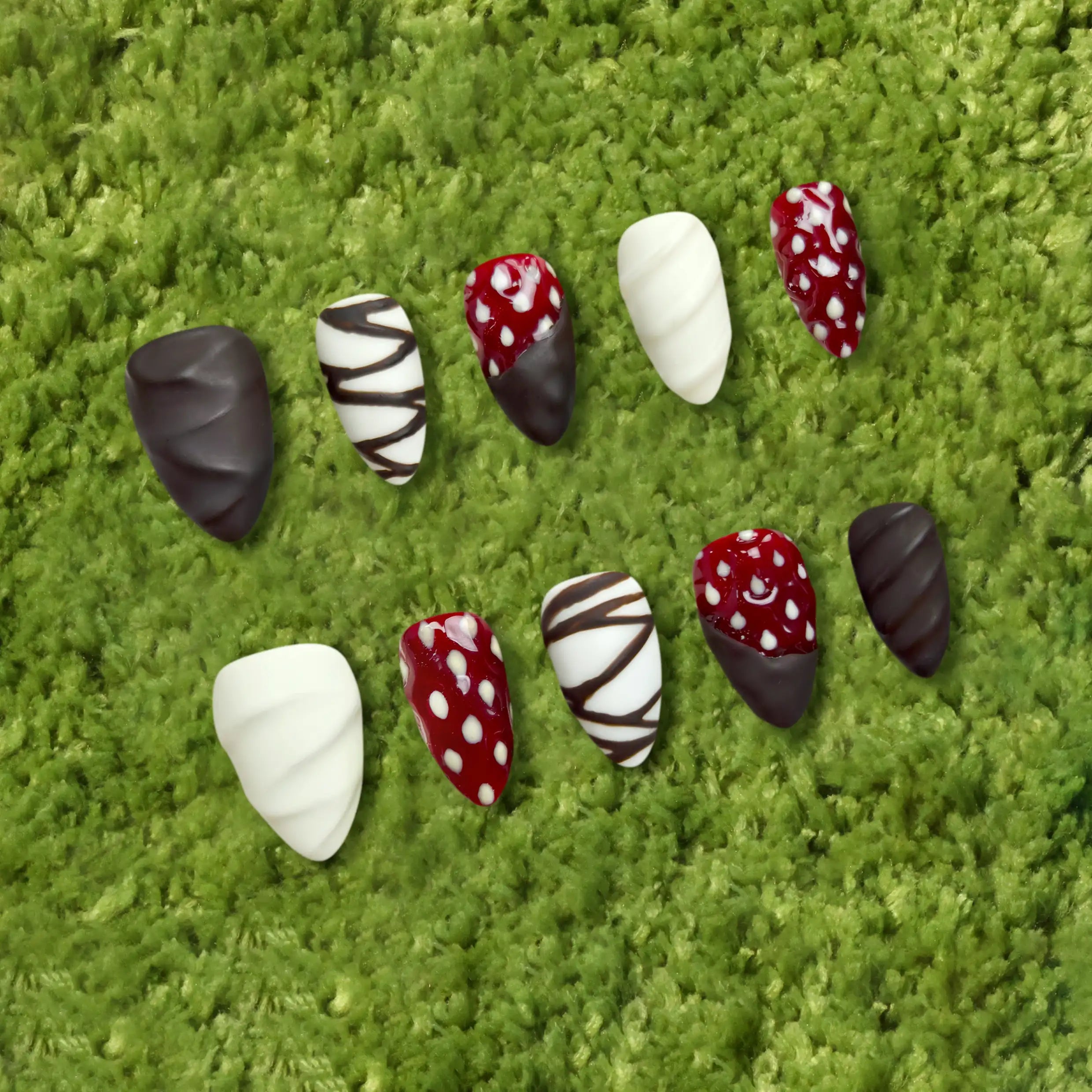 Product display showing full set of matte brown and white almond nails with sculpted strawberry elements