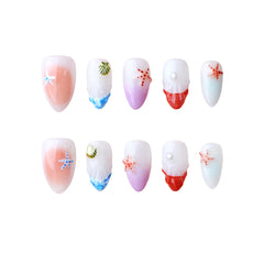 Pink almond press on nails with coral gradient and seashell accents for summer.