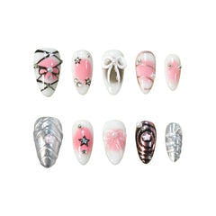 Medium pink almond press-on nails with silver chrome ombré, 3D bows, and star details for a cosmic glam look.