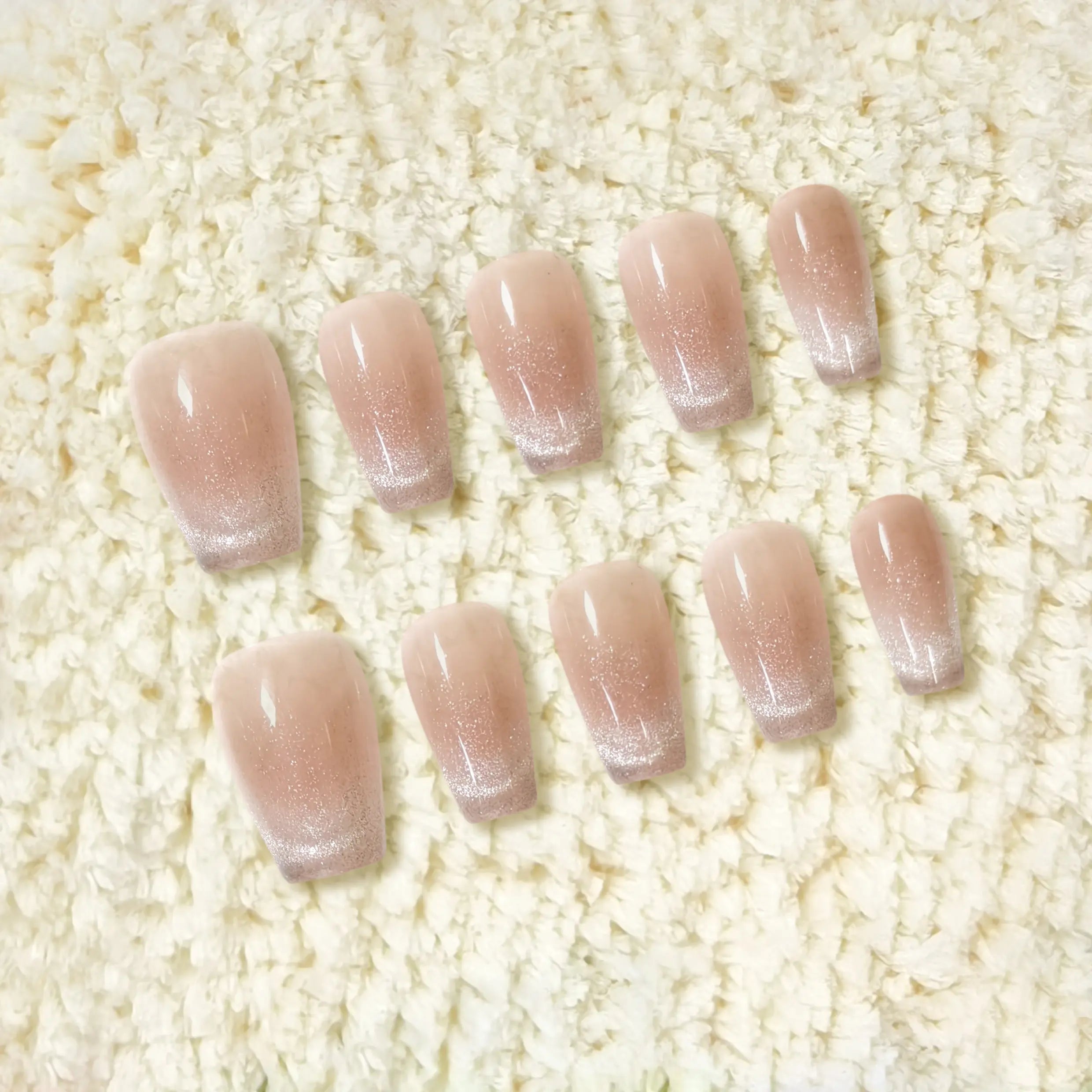 Full nail tip layout showcasing the nude shimmer ombré effect