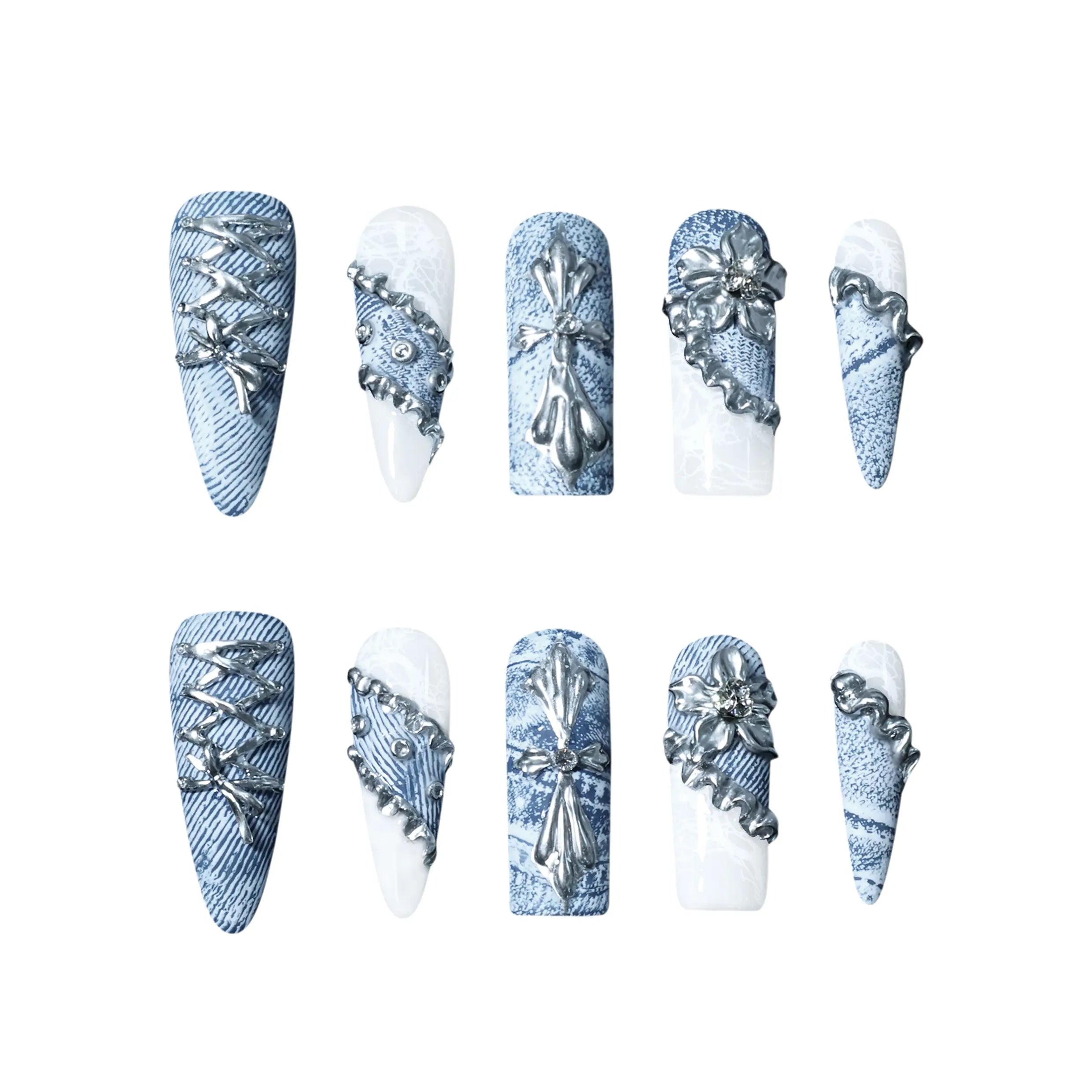 Blue denim-inspired stiletto-shaped press-on nails featuring white marble accents, metallic lace-up designs, and floral appliqués.