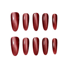 Long oval press on nails in metallic red shimmer, elegant and festive.