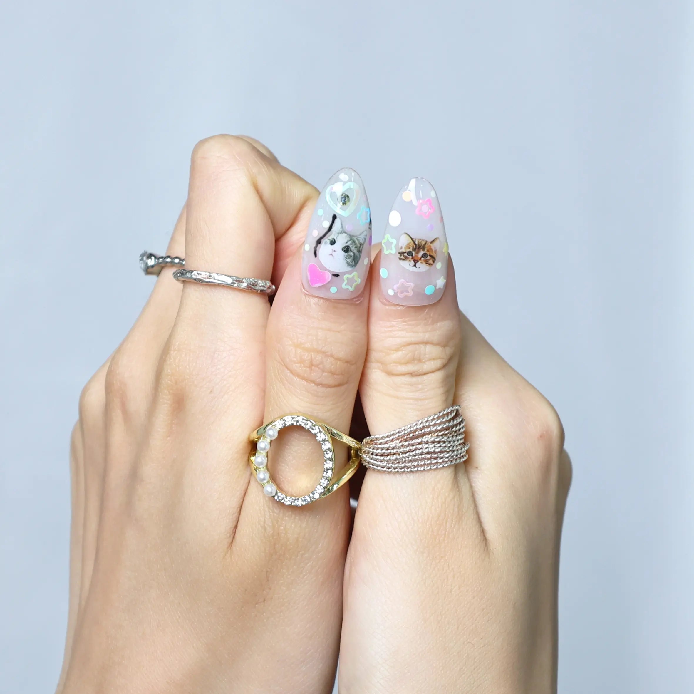 Fun summer manicure with pastel pink tones, kawaii embellishments, and raised fruit and floral designs