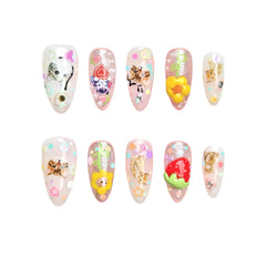 Playful pink almond press-on nails with glitter, strawberries, flowers, and 3D kawaii characters, perfect for a cute and fun manicure.