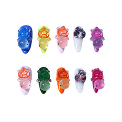 Colorful long almond press on nails featuring 3D turtle charms in blue, green, pink, and orange with crystal accent designs.