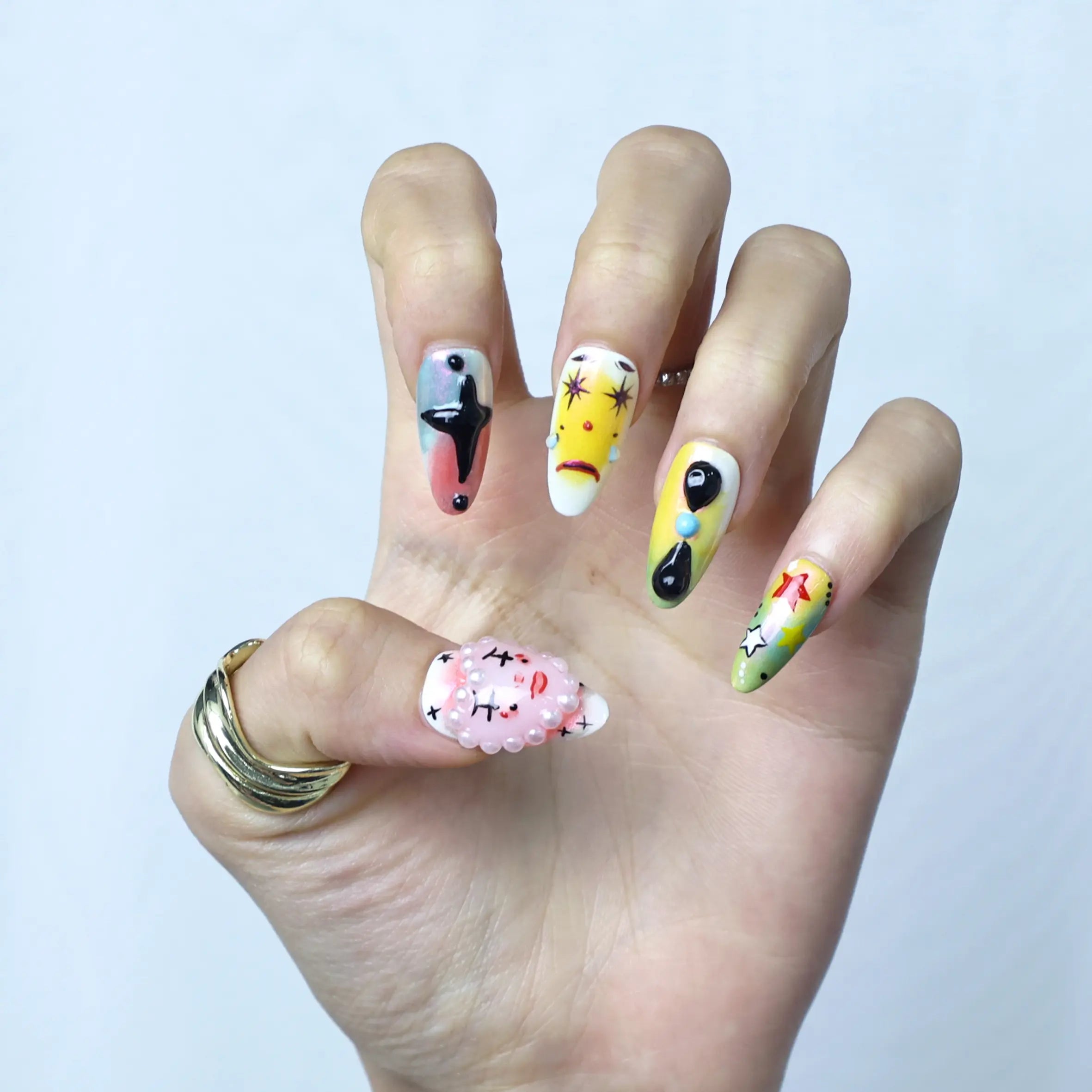 Close-up of kawaii press-on nails with bright characters, glossy finish, and raised eye embellishments