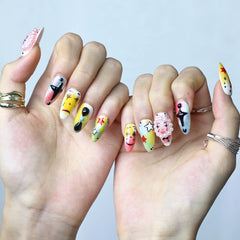 Fun summer nails with animated faces, candy colors, and dimensional details in almond shape