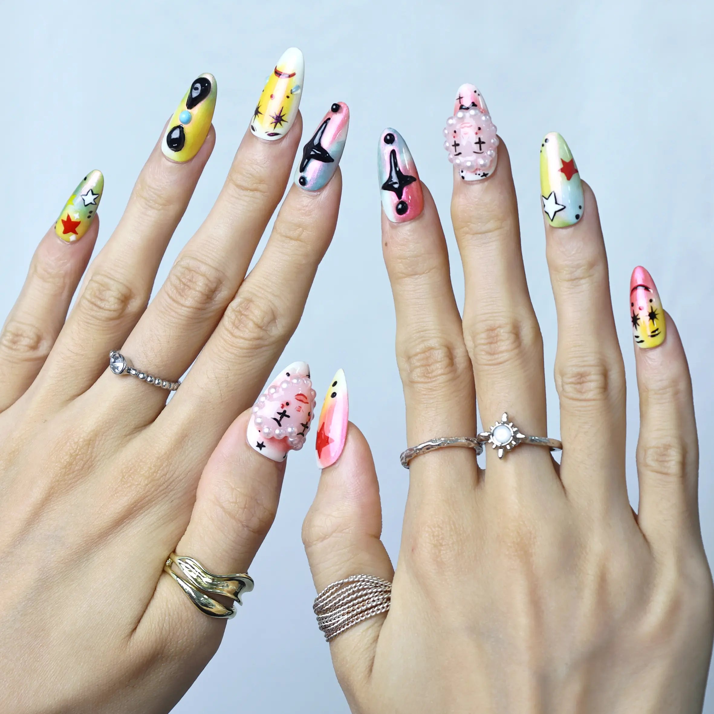 Side view of cute press-ons featuring cartoon eyes, tiny stars, and a joyful circus-inspired design