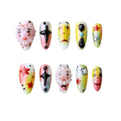 Kawaii medium almond summer nails with cartoon eyes, colorful characters, and a pink base.