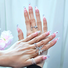 Coffin summer nails with cartoon kitten details and silver gradient worn by model with rings