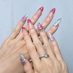 Close-up of almond-shaped press-ons featuring pearl decor, bold leopard design, and pink base