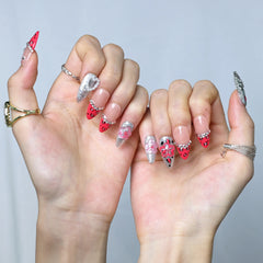 Glamorous pink nails with mixed textures—glitter, animal print, and sculpted flowers