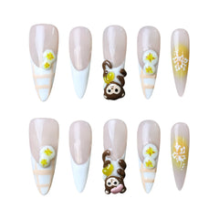Long stiletto press on french nails with white tips, monkey artwork, and 3D banana details.
