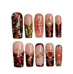 Red long press on nails with tortoiseshell texture, 3D hearts, and gold charm accents.