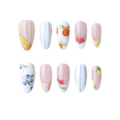 Medium almond press on nails in soft pink with floral and fruit designs.