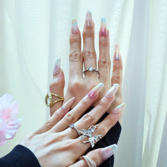 Close-up of medium coffin nails featuring seashell-inspired gradients and pearl decor