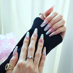 Pastel press-on nails with ocean wave texture and subtle glitter, styled on hands with jewelry