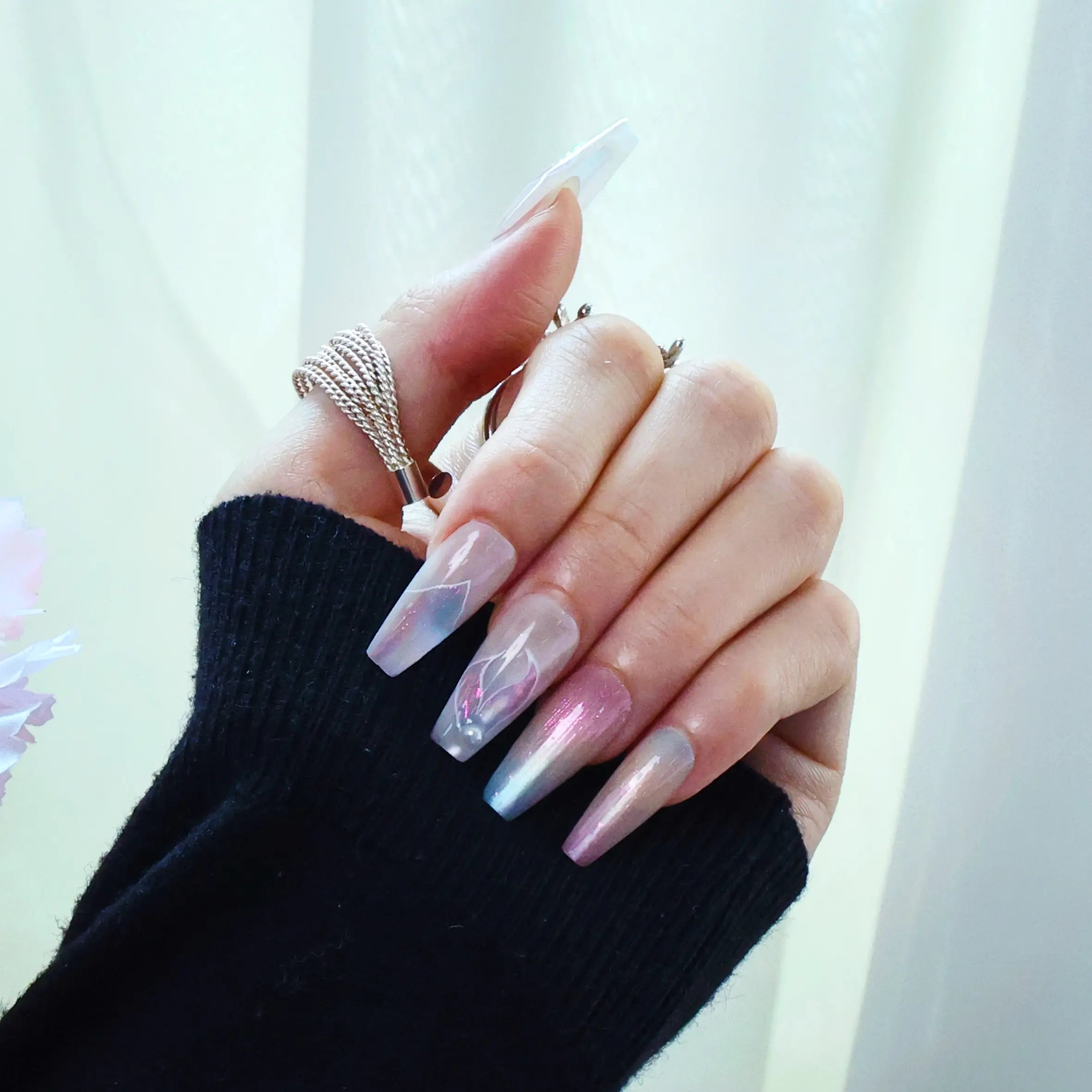 Side view of 3D mermaid-inspired nails with iridescent finish and pearl embellishments