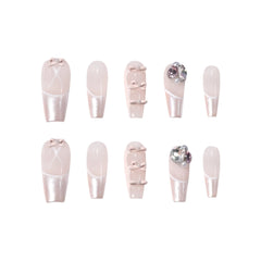 Square pink press-on nails with pearlescent French tips, 3D bows, rhinestones, and soft glam details. Perfect for weddings or elegant daily wear.