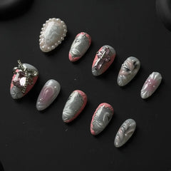 Medium metallic almond press on nails with gradient shimmer, and pearl accents.