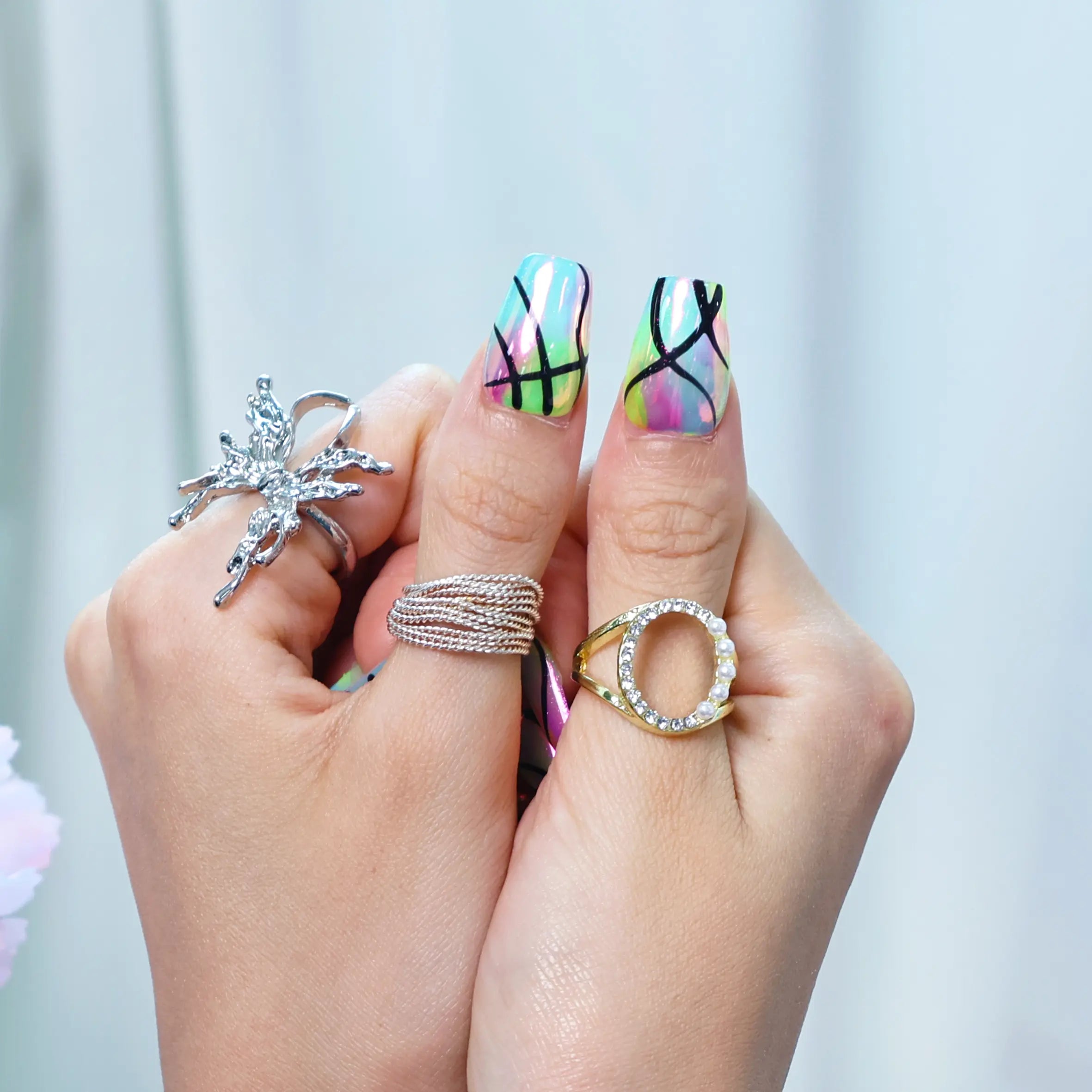 Close-up of press-on nails with blacklight-inspired color shift