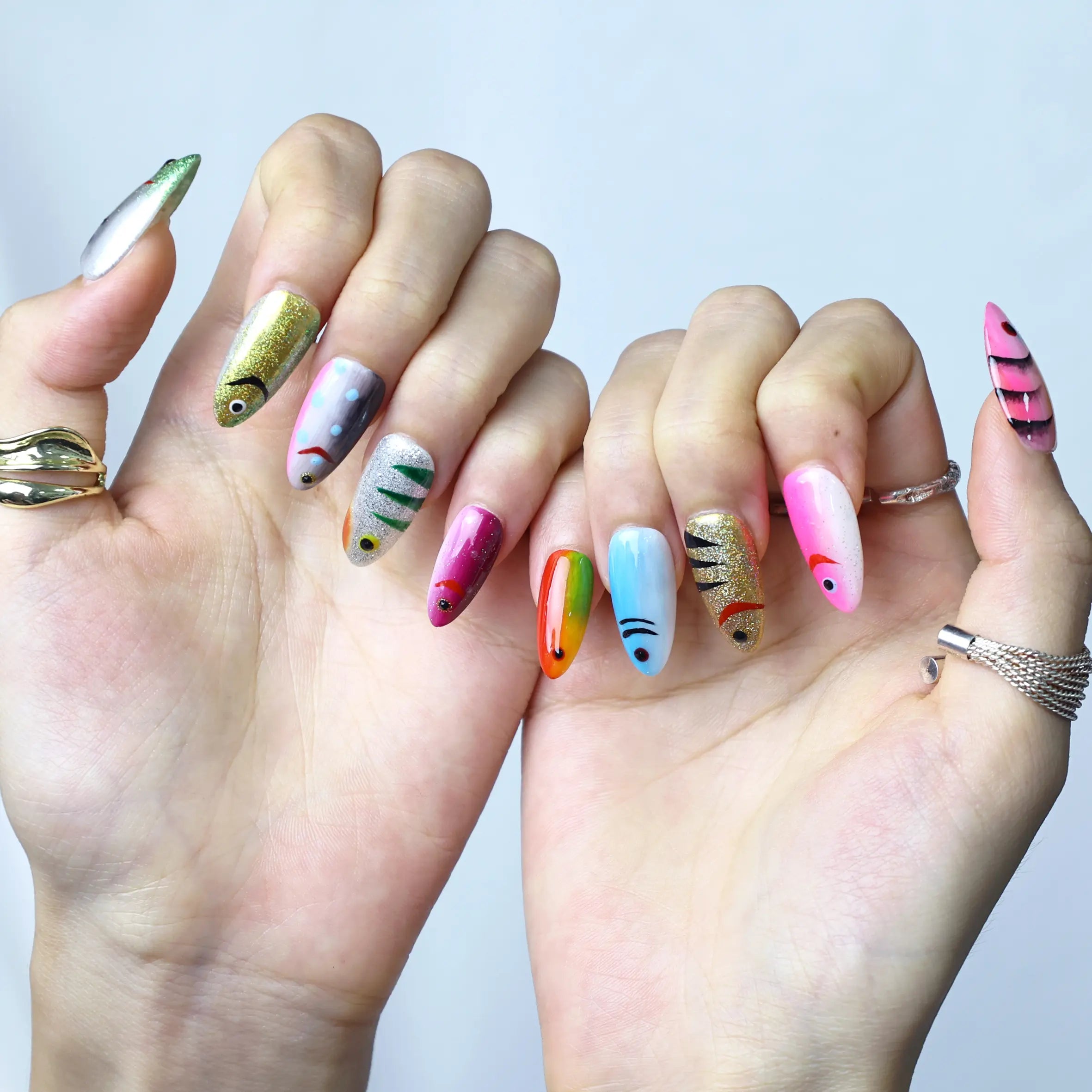 Underwater-inspired manicure with embossed fish scale patterns and iridescent ocean colors