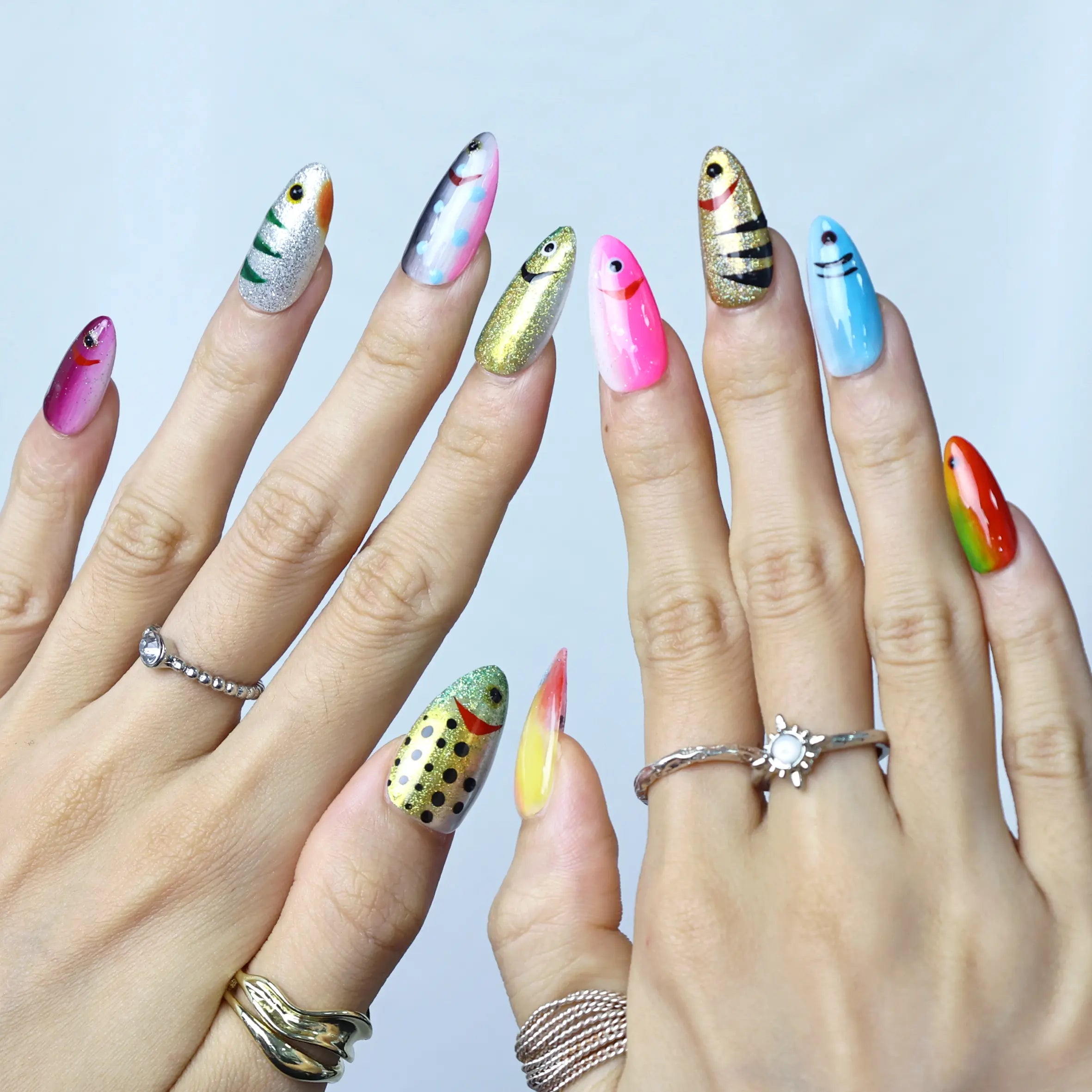 Glossy blue press-on nails styled with summer beach vibes, featuring marine texture and depth