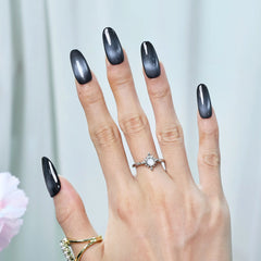 Medium squoral black press-on nails with glossy finish on hand