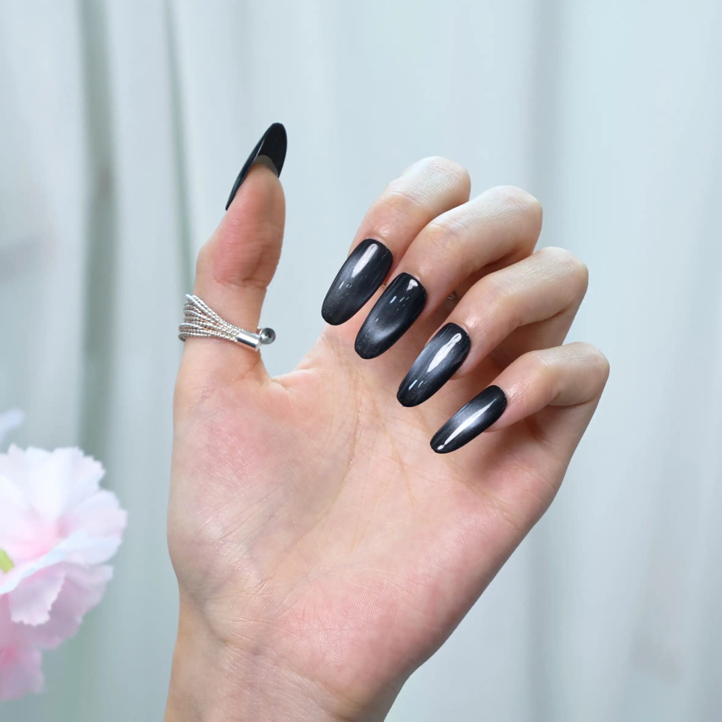 Press-on nails in jet black with a smooth, reflective shine