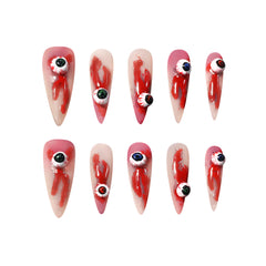 Haunting long black stiletto press-on nails with 3D eyeball and dripping blood designs, perfect for Halloween and horror fashion looks.