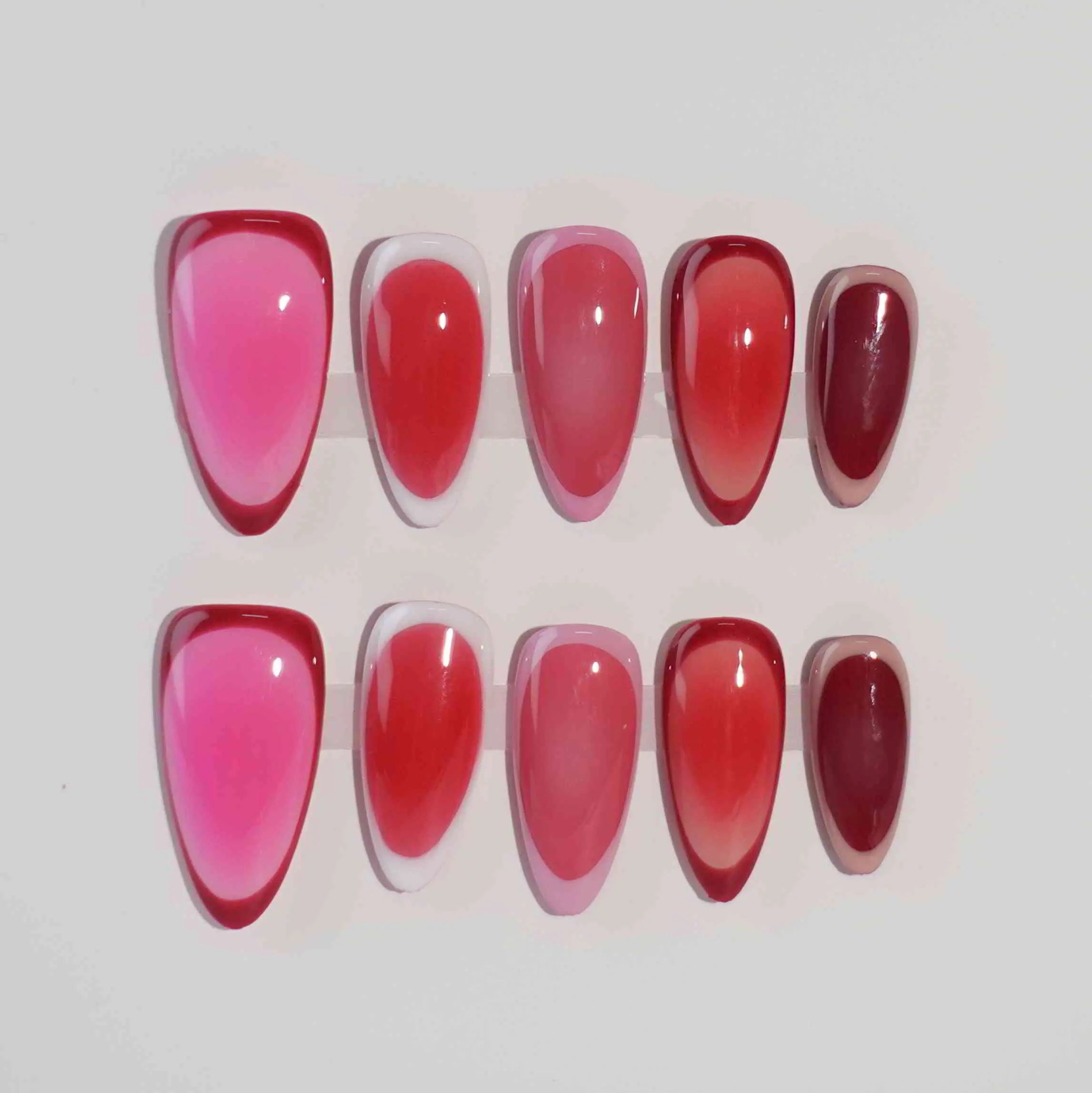 Gradient pink almond press on nails with seamless ombré from soft rose to bold ruby.